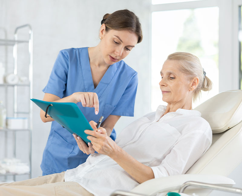 Licensed Healthcare Professional with a patient signing documents